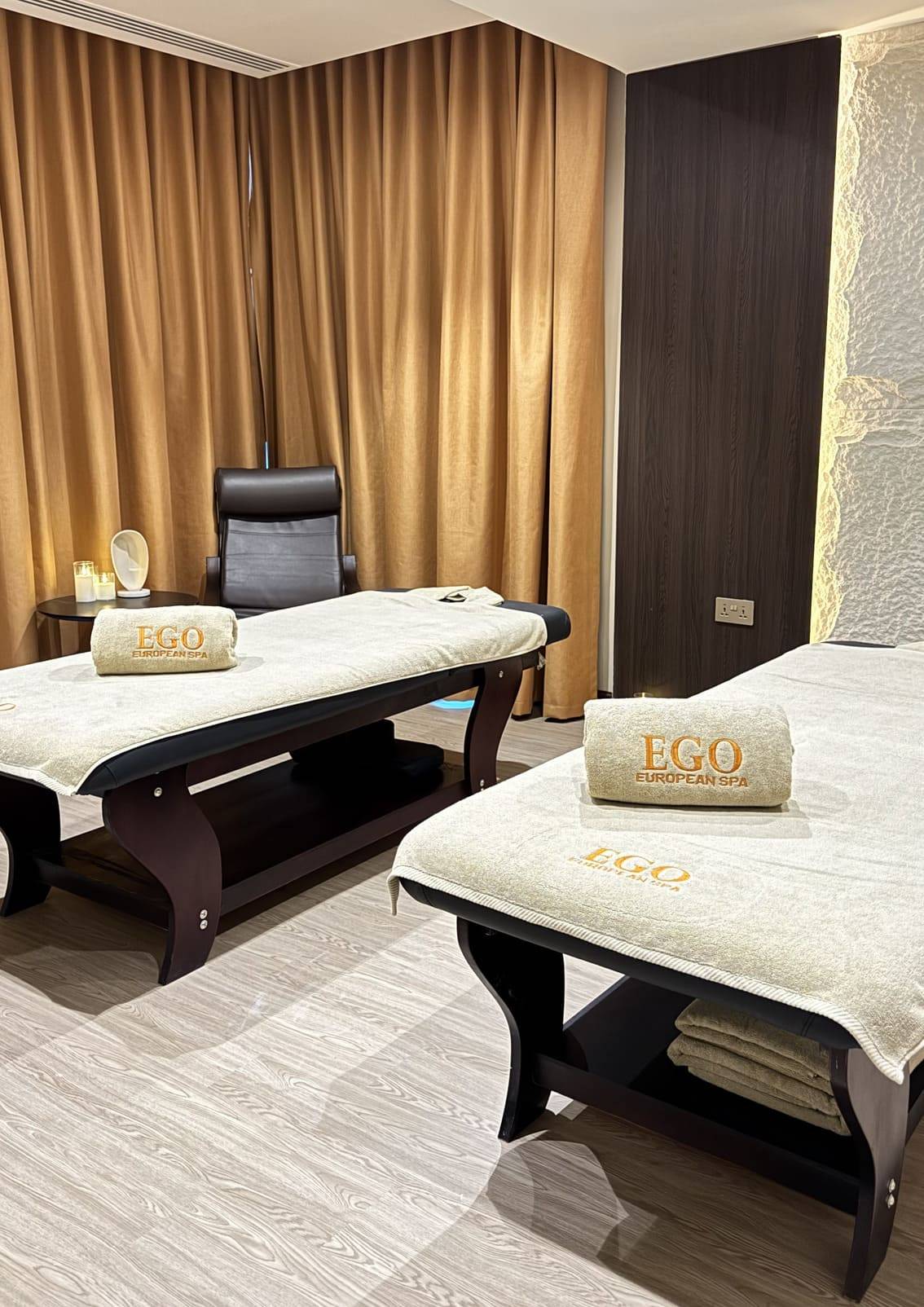 Couples treatment suite at Ego European Spa Dubai prepared with two massage tables and candles