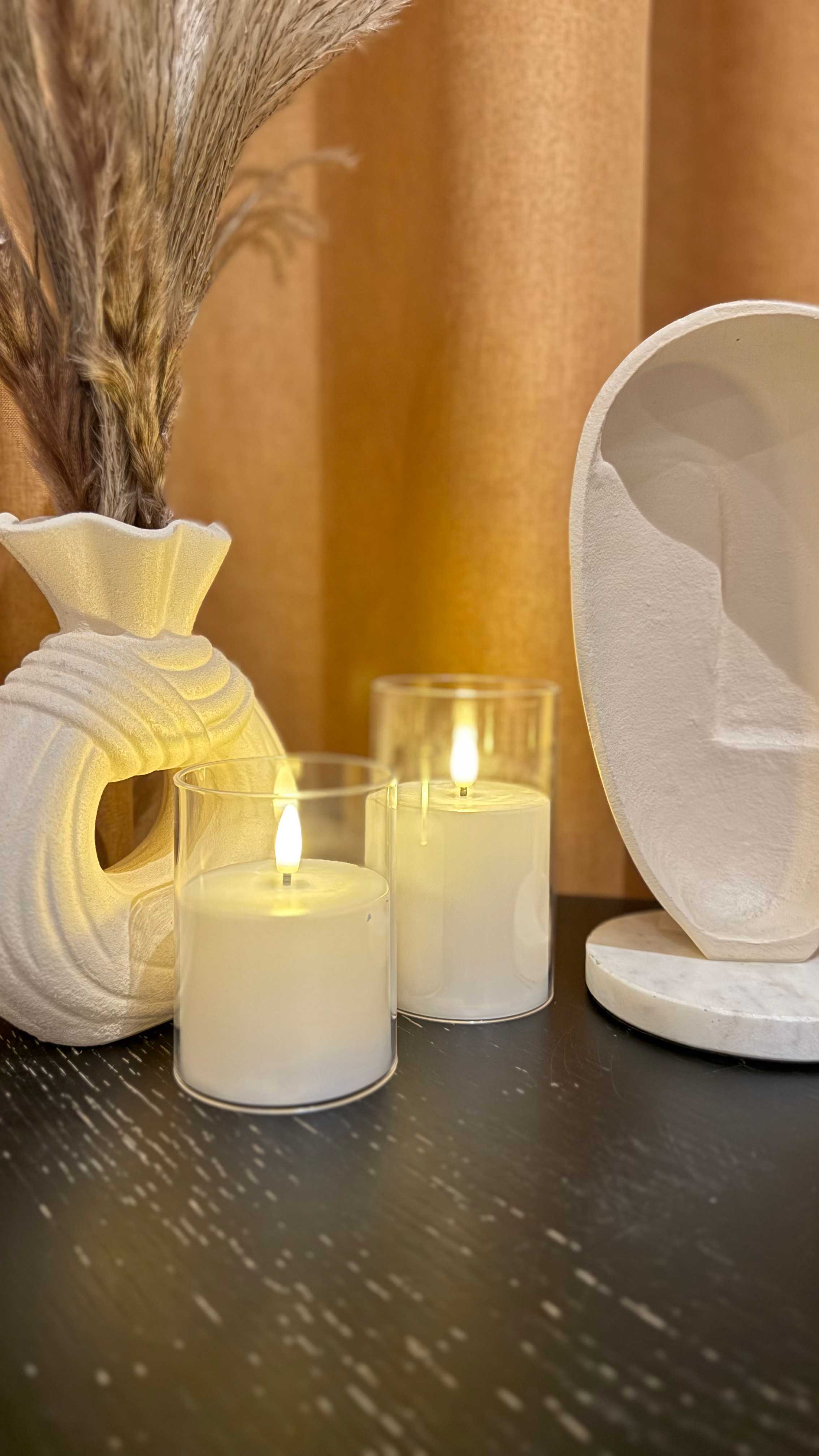 Candle-lit treatment room detail at Ego European Spa Dubai — lit candles beside dried pampas grass